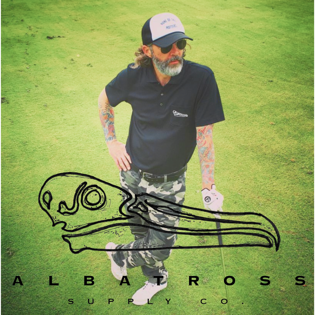 Hip tattoo golfer with albatross shirt and None of this matters hat